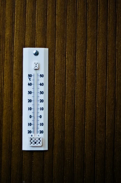 Room thermometer on a wooden wall close up — Stock Photo, Image