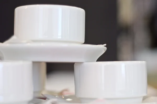 stock image Three white porcelain tea cups and saucers and napkins close up