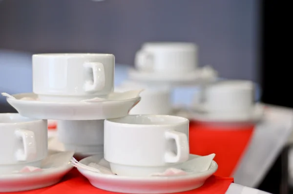 stock image Three white porcelain tea cups and saucers and napkins close up