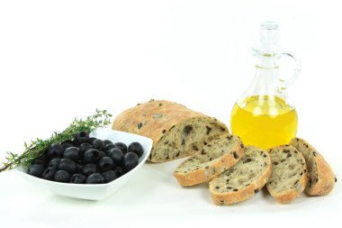 Sliced Loaf Mediterranean Ciabatta black olive bread, olives, olive oil, ingredients over white background. clipart