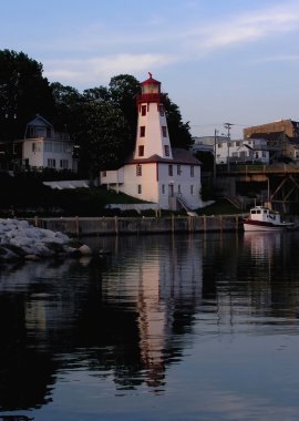 Lighting house and marina caanel on sun set vertical view. clipart