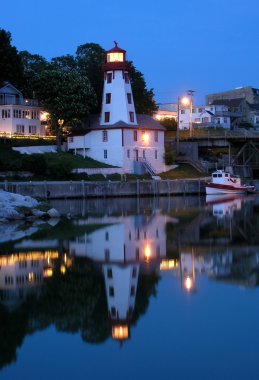 Lighting house and marina caanel night view. clipart