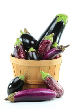 Different sorts Organic Eggplants - Regular Eggplants, Baby Graffiti Eggplants, Baby Italian Eggplants, Chinese Eggplants in wooden basket Bushel, over white ba clipart