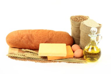 Still life picture of products (Hard Wheat Kernels, whole wheat flour, Olive Oil, Eggs, wheat ears, Old Cheddar Cheese) use to made Old Cheddar Cheese Bread ove clipart