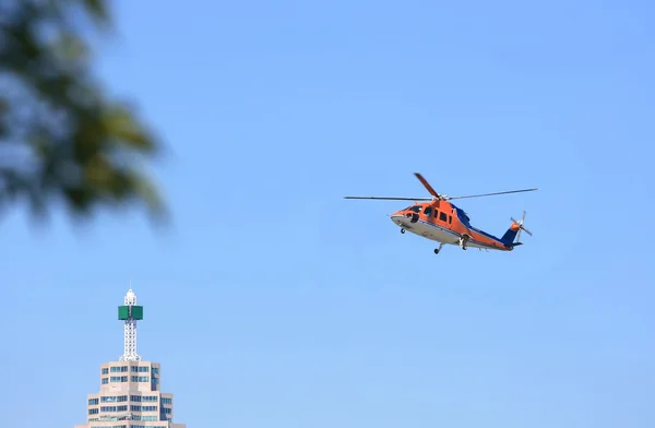 Helicopter flying in sky of Toronto.