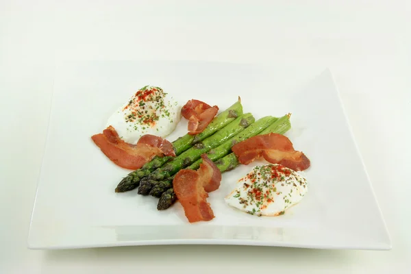 stock image Backed asparagus, Poached Eggs and fried Bacon.