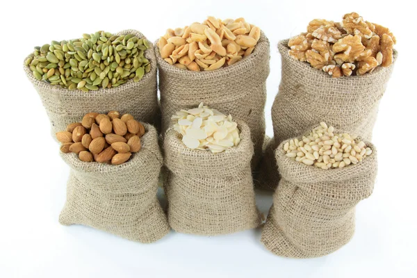 Nuts and seeds in burlap bags. — Stock Photo, Image