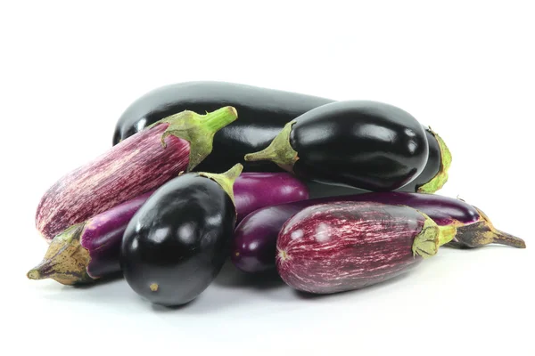 Pile assorted Eggplants on white. — Stock Photo, Image
