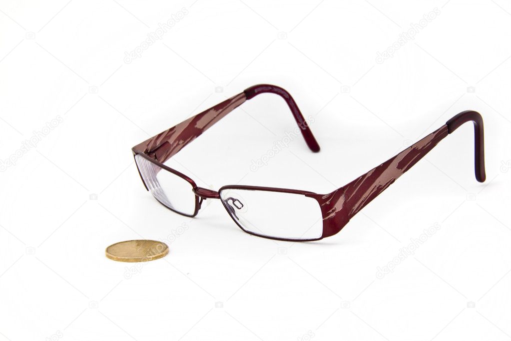 A pair of eye glasses keeping a close eye on a canadian dollar bill.