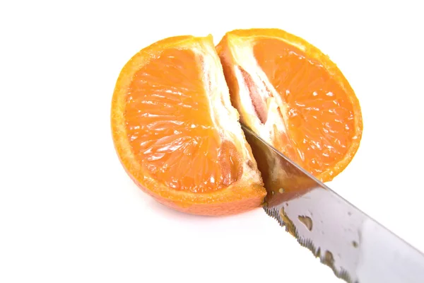Mandarin orange skär med en kniv — Stockfoto