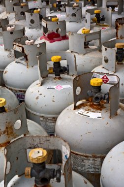 Rows of tanks filled with flammable gas. clipart