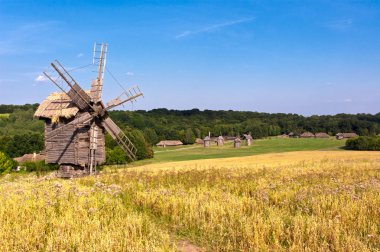 Old wooden windmill in the countryside clipart