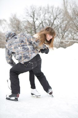 Happy couple on the skating-rink clipart