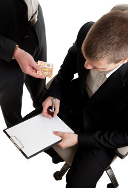 Closeup of a businessman signing a contract beeing bribed clipart