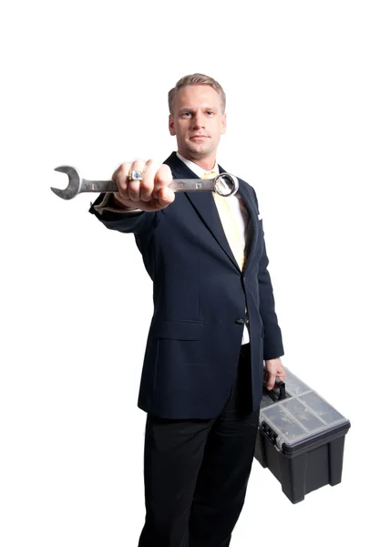 Businessman holding wrench and toolbox — Stock Photo, Image