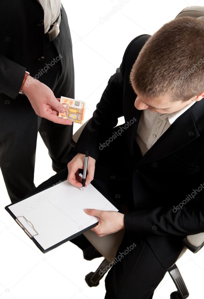 Closeup of a businessman signing a contract beeing bribed