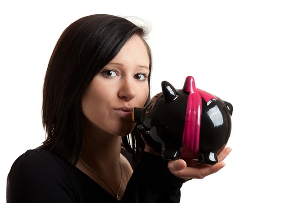 Young woman piggy bank kiss closeup — Stock Photo, Image
