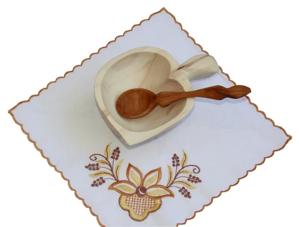 A wooden plate on the embroidered napkin — Stock Photo, Image