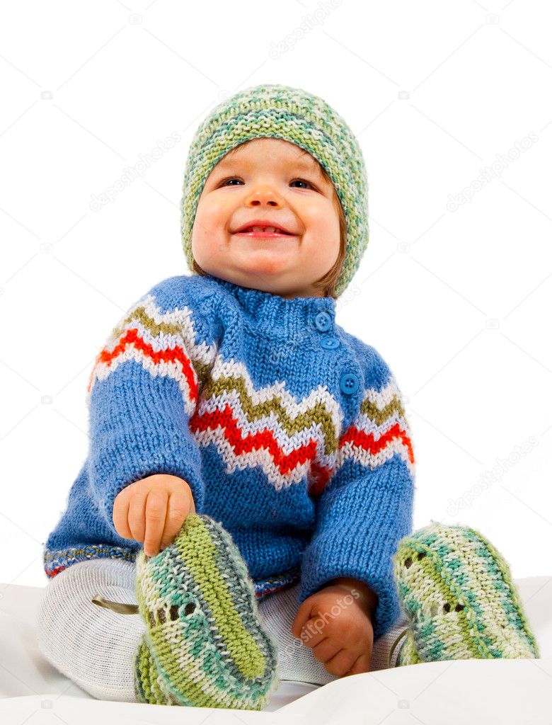 Smiling Kid who is sitting in Studio