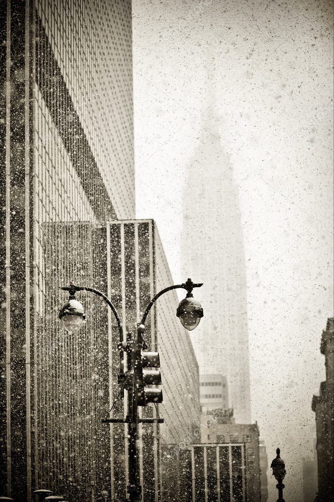 Old-fashioned stylization of silhouette of Empire State building in blizzar
