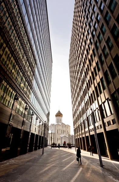 Vieille église russe entre deux gratte-ciel modernes — Photo