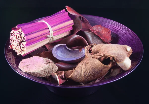 stock image Purple pot-pourri in purple bowl on black background