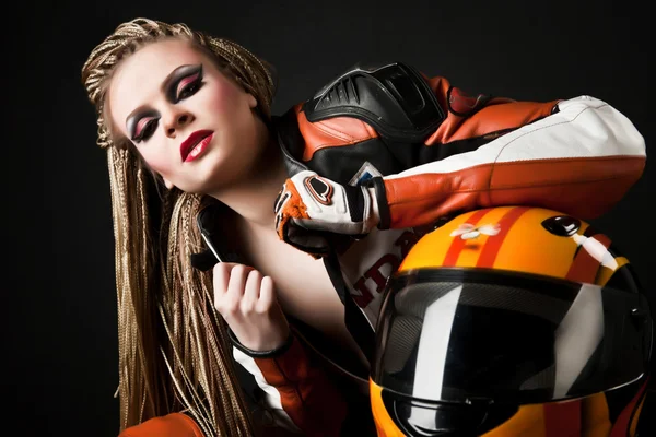 Stock image Young sexy blonde in a motorcycle jacket and helmet in her hands