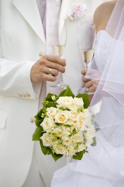 Bride and fiance hold glasses of champagne clipart