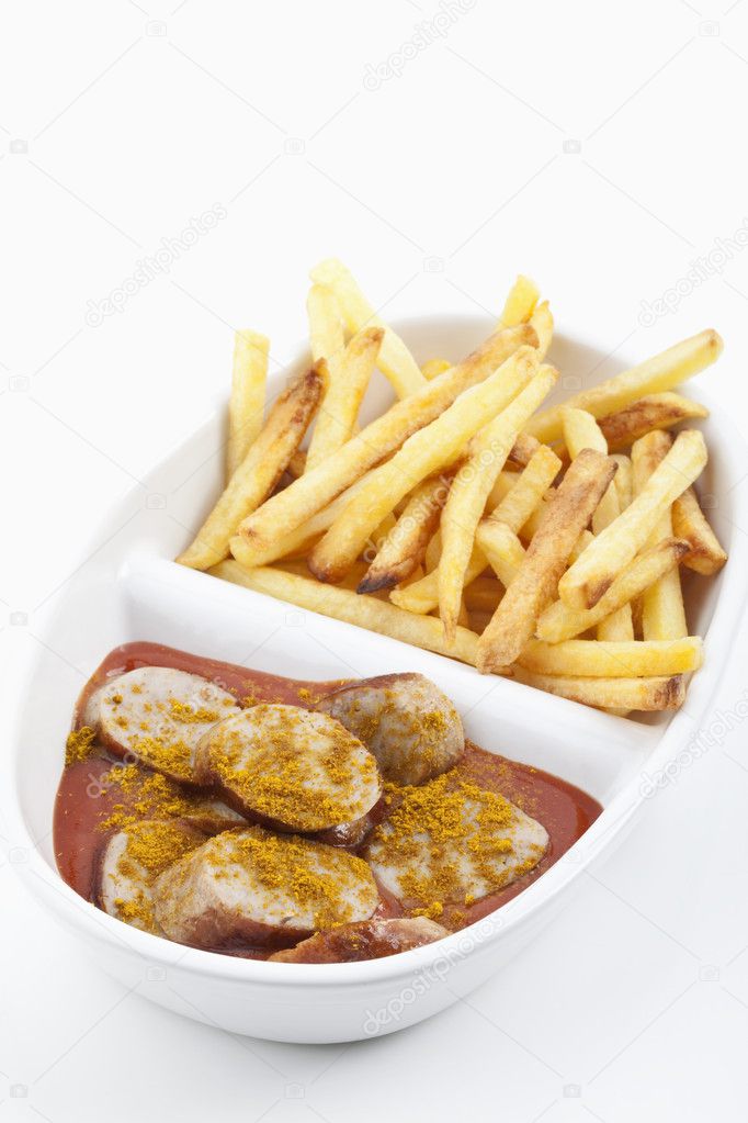 A caurried sausage with french fries,Eine angerichtete Currywurst mit Pommes