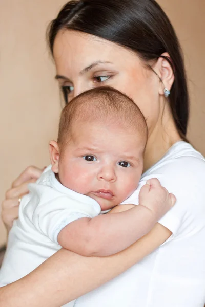 stock image A small child on his mother's arms