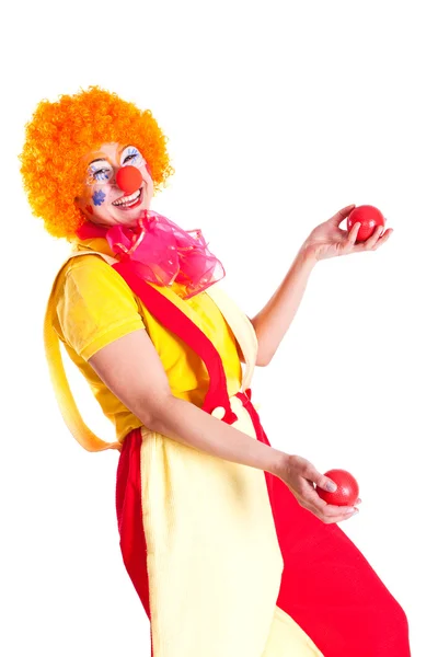Mädchen als Clown verkleidet jongliert — Stockfoto