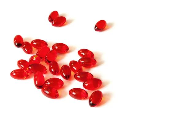 Rote Pillen auf weißem Tisch — Stockfoto