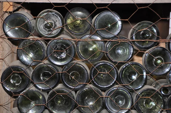 Staré lahve v skladovací regály — Stock fotografie