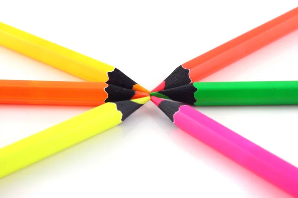 Neon pencils pointing at each other — Stock Photo, Image