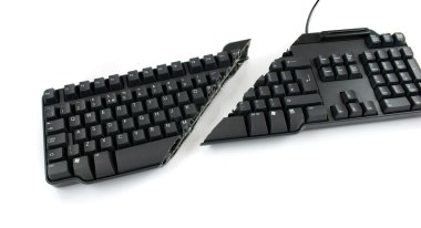 Modern keyboard cut completely in half showing keys and wires still in place clipart