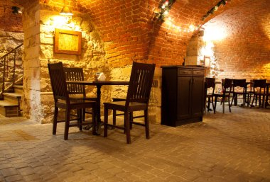 A cozy café with brick arches and warm lighting. clipart