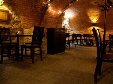 A cozy café with brick arches and warm lighting.