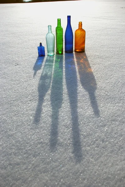 stock image Colored bottles on snow