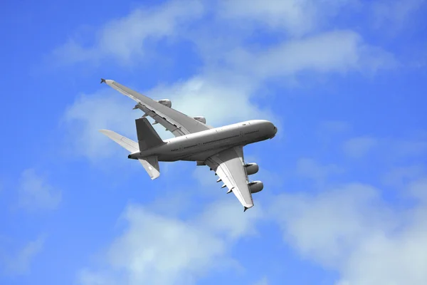 stock image Passanger airliner flight over a cloud covered background