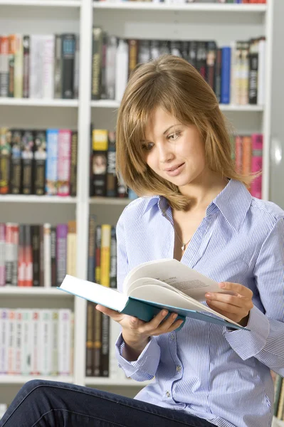 年轻漂亮的女人阅读书在图书馆 — 图库照片
