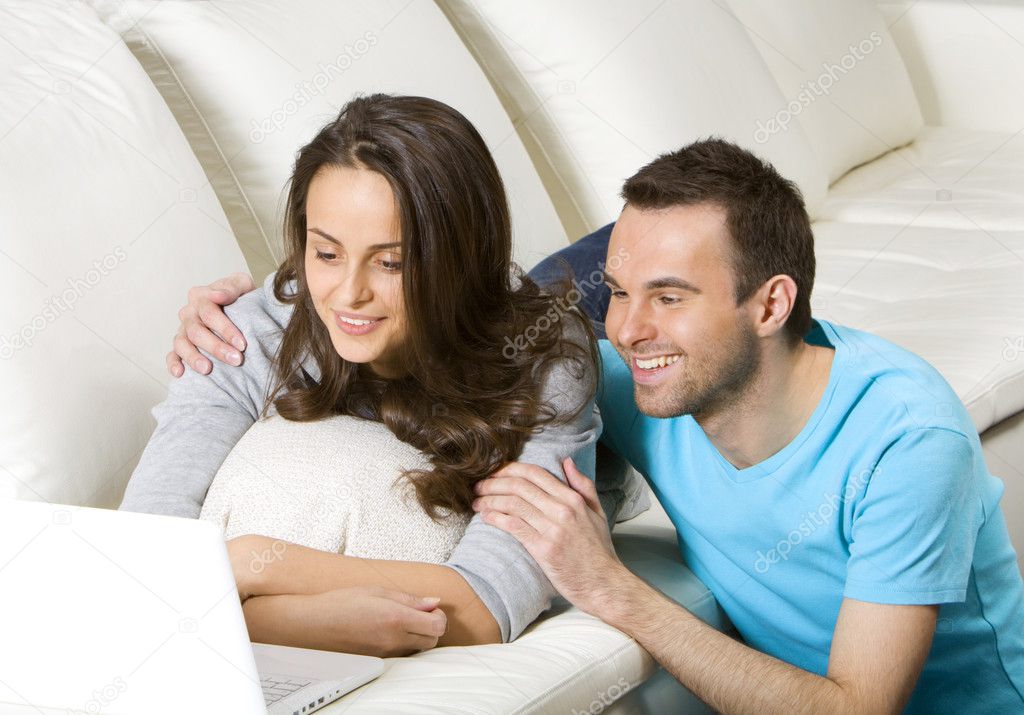 Happy young couple with laptop