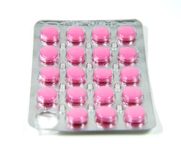 Pílulas cor de rosa em uma bolha . — Fotografia de Stock