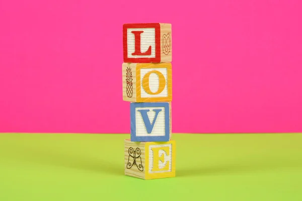 Word Love Spelled Childrens Block Pink Green Background — Stock Photo, Image