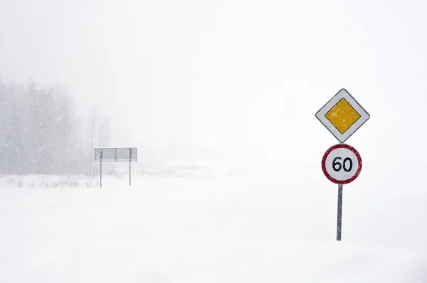 stock image Warning sign in the road at Winter. Blizzard