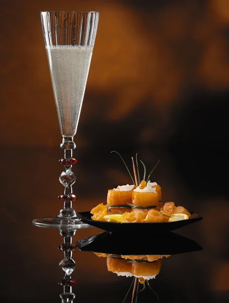 stock image Glass of Champagne and Salmon Rolls