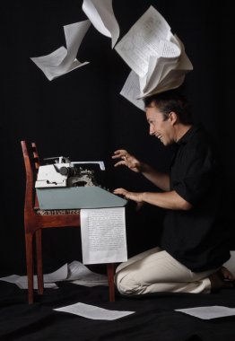 The writer selflessly prints on the typewriter, and sheets around fly clipart