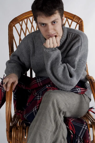 Portrait of a young man in a rocking chair — Stock Photo, Image