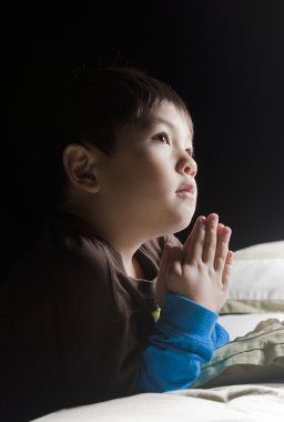 Saying his prayers before bed. clipart