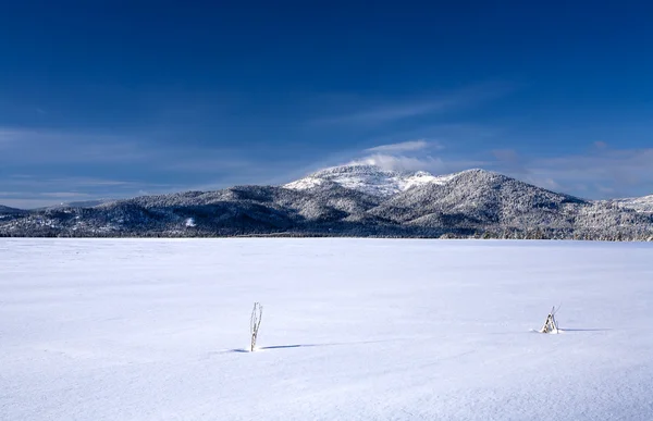 Pole pokryte śniegiem i góra. — Zdjęcie stockowe