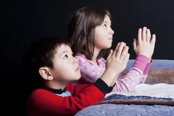 一个哥哥和姐姐睡前只是说他们的祈祷 — 图库照片